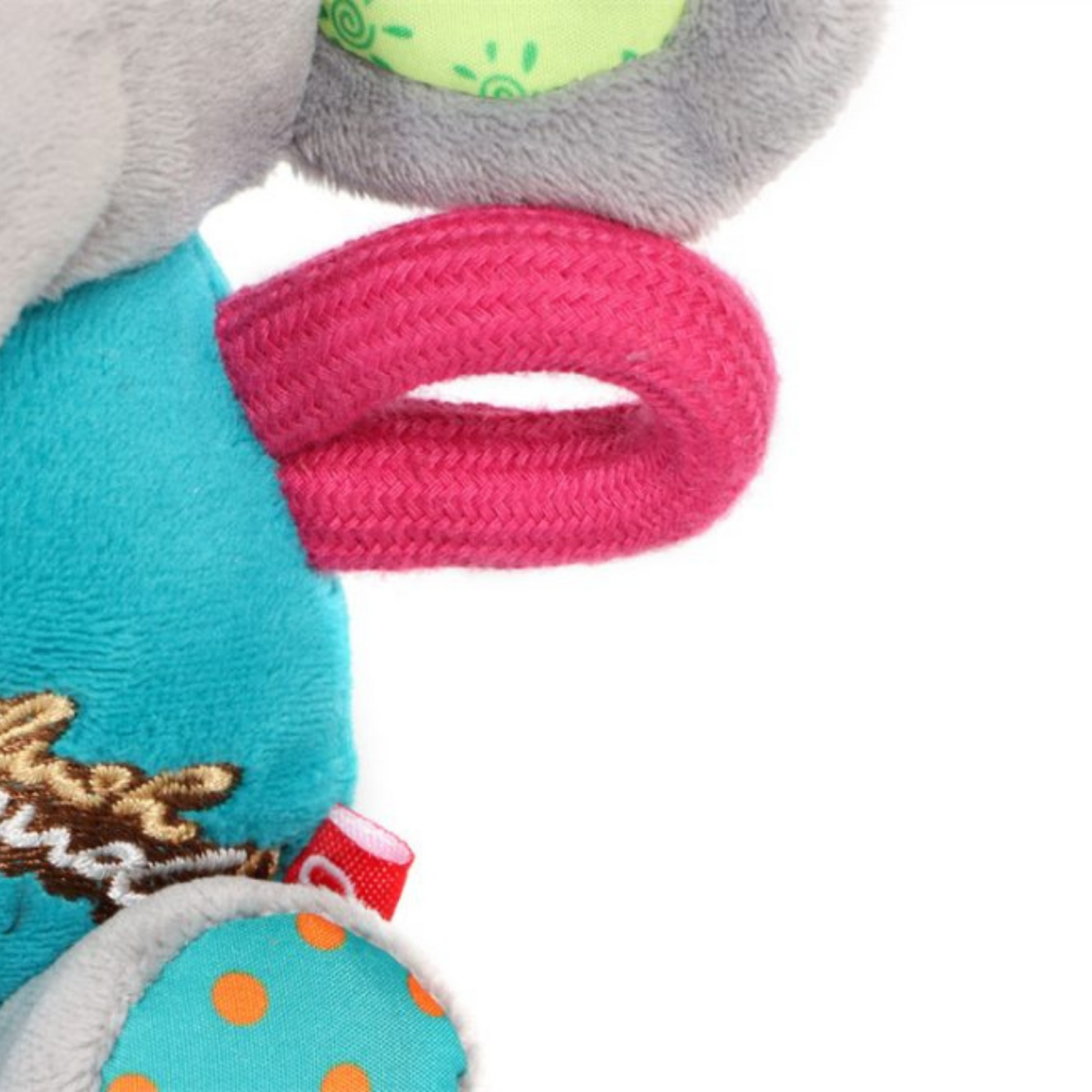 Close-up of a colorful dog toy with a pink rattle and teal body on a white background