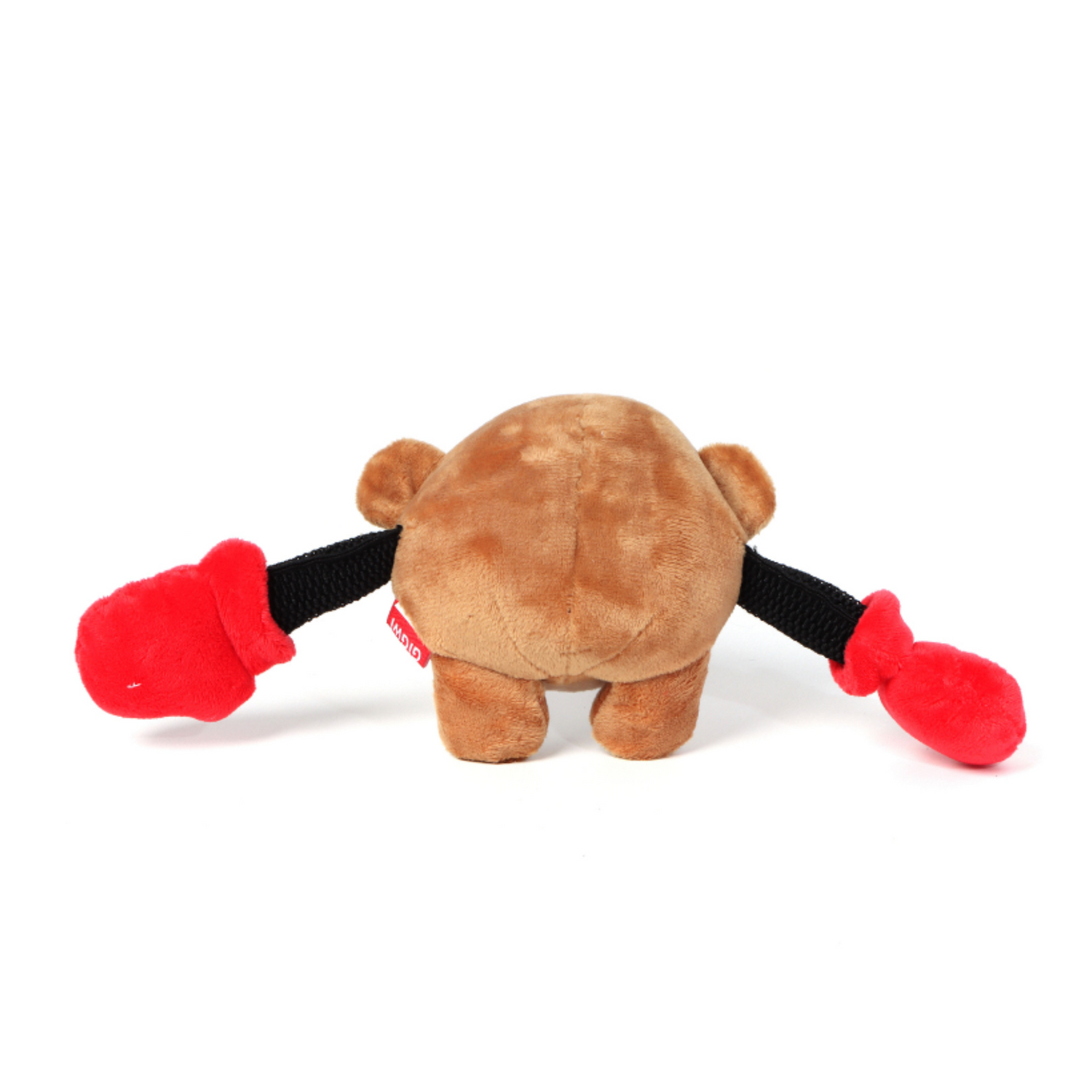 Brown plush dog toy with red paws and a black strap on a white background