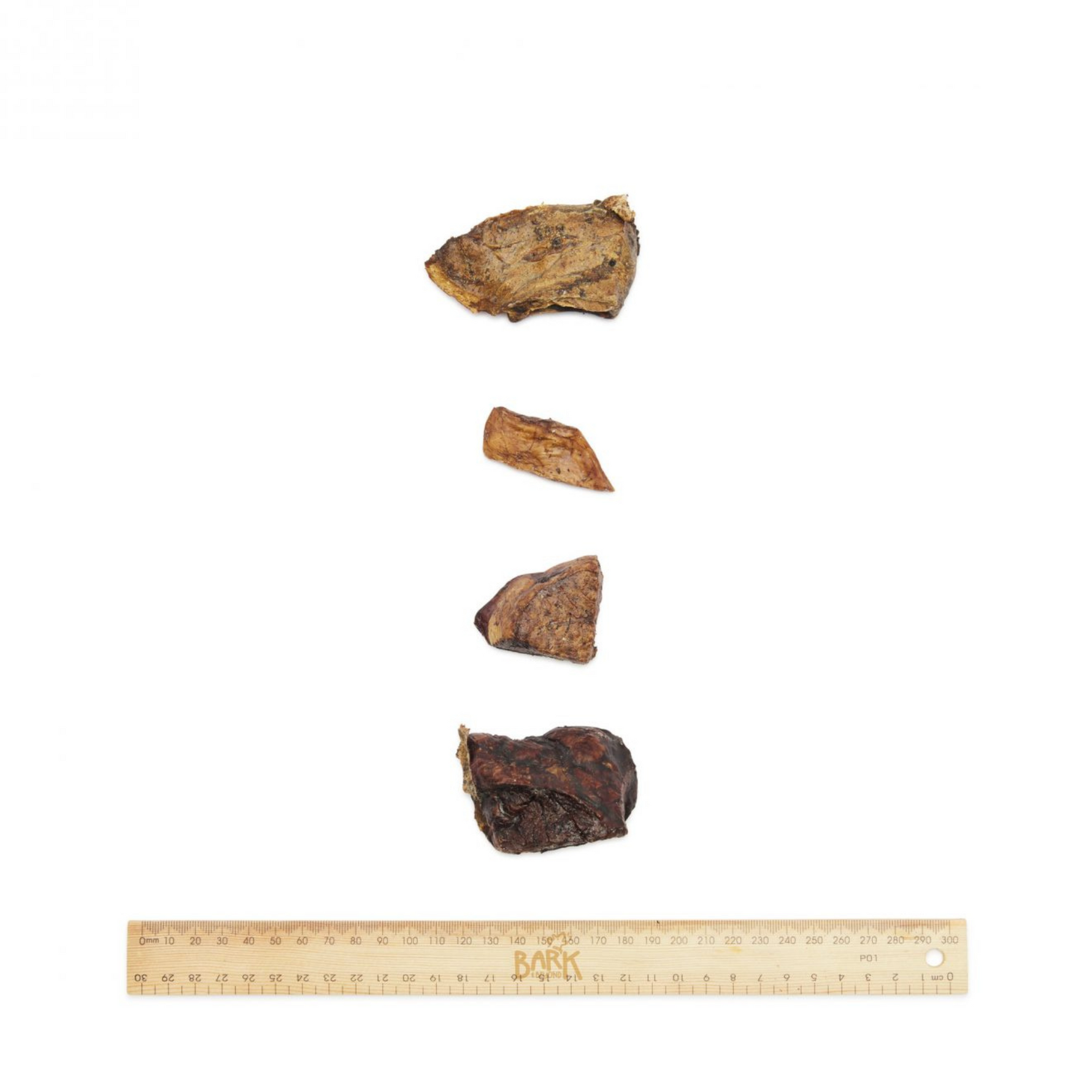 Four pieces of beef cubes bark and beyond on a white background.