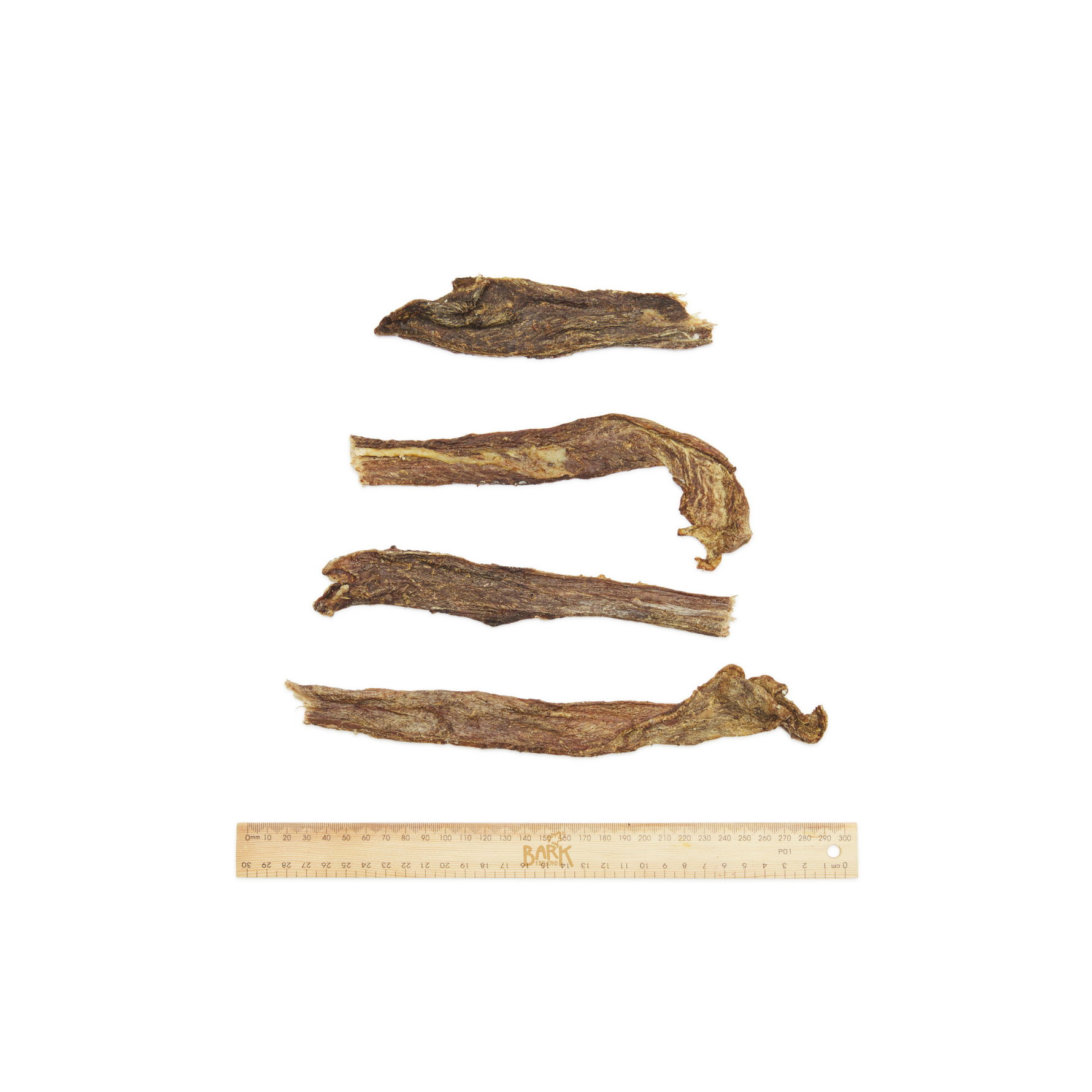 four dried beef jerky pieces on a white background.