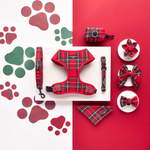 Collection of red plaid pet accessories including a harness, collar, and bandana on a red and white background with paw prints.