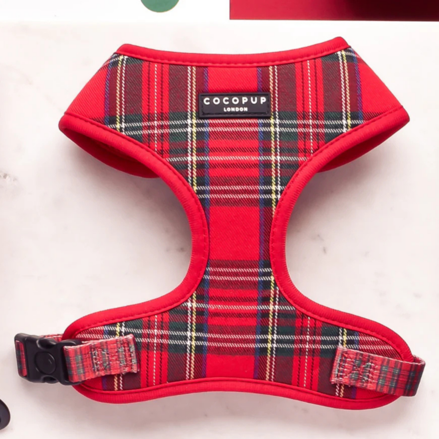 Red plaid dog harness with 'CocoPup' label on a white background