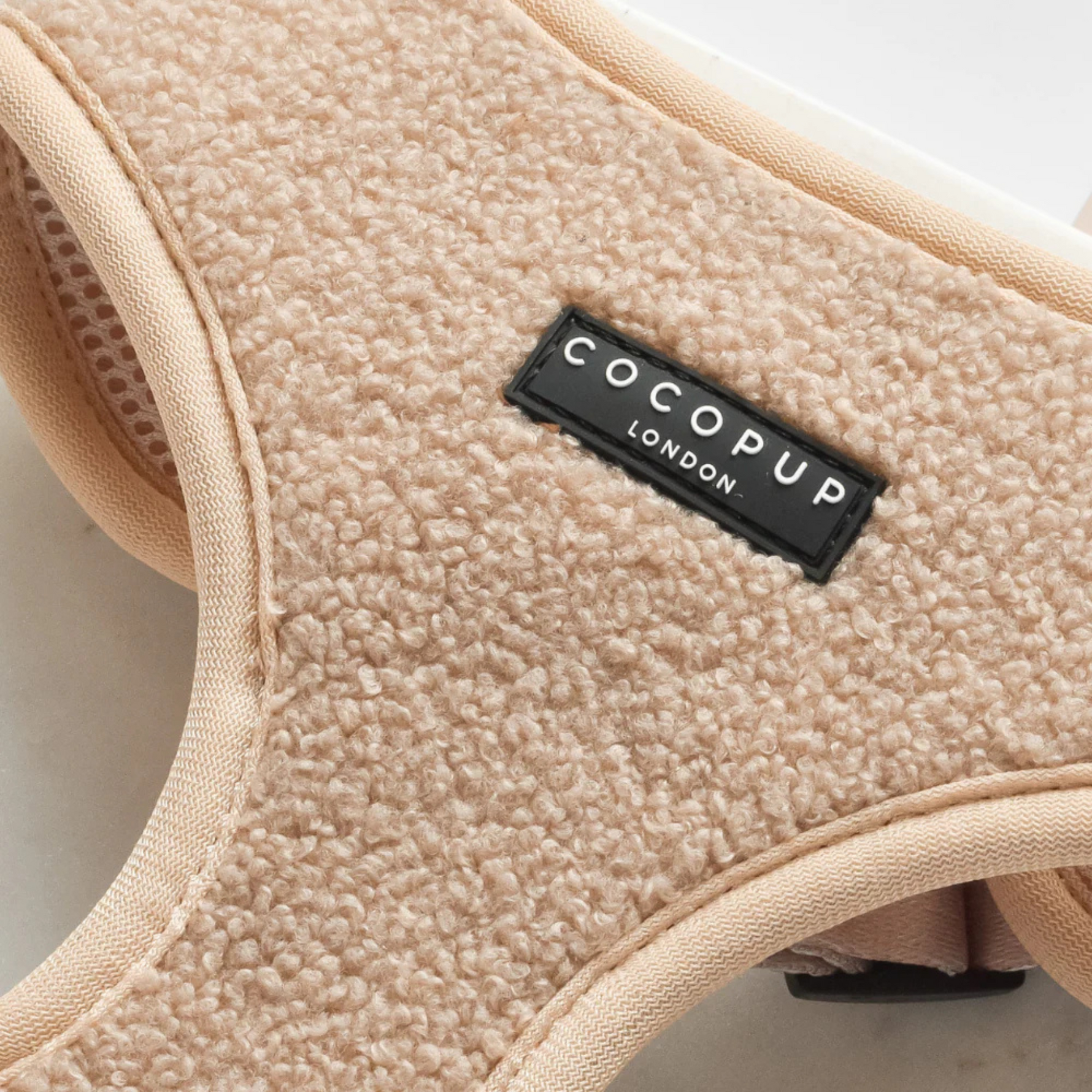 Close-up of beige textured product with 'Cocopup London' label