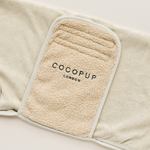 Beige fleece blanket with COCOPUP London label on a light background