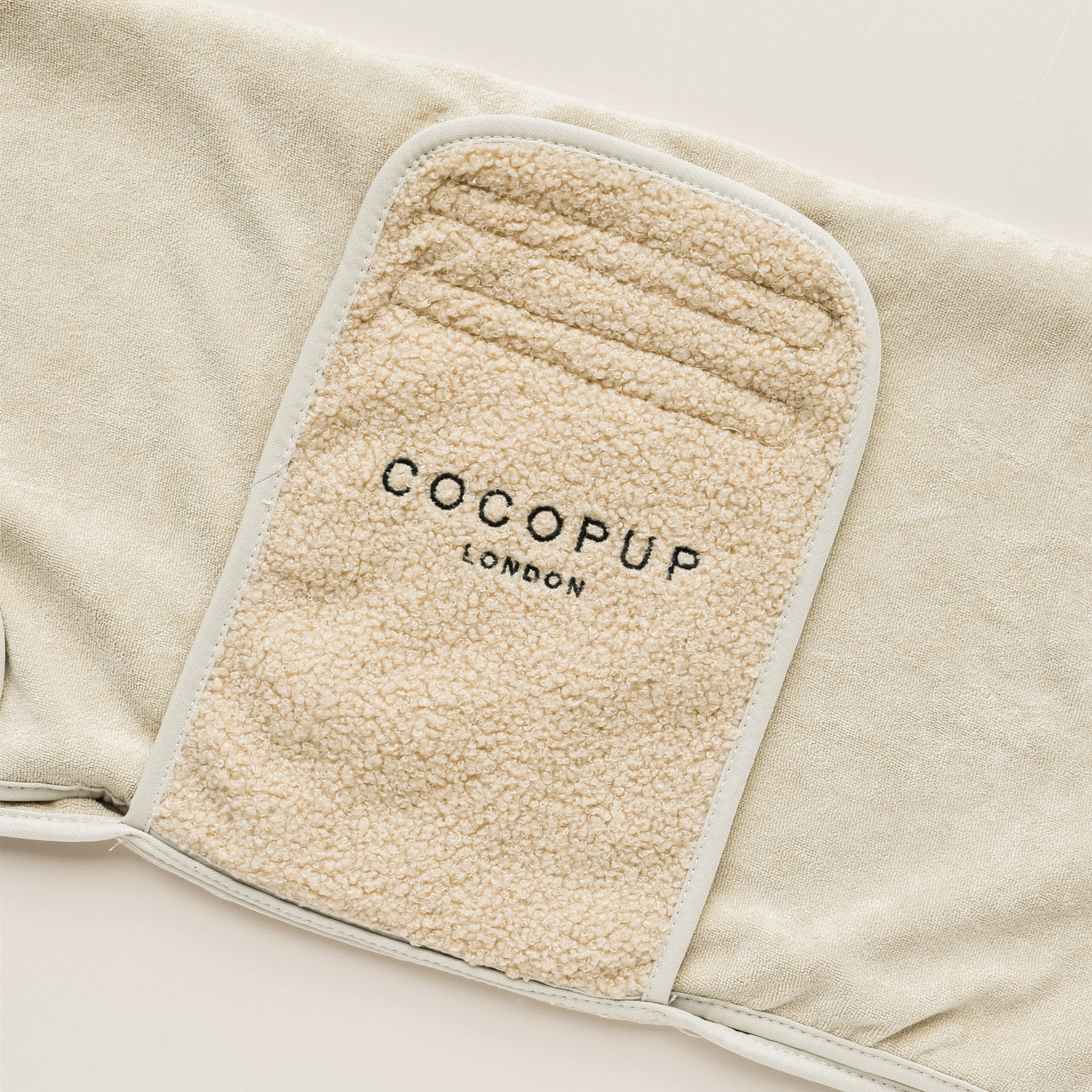 Beige fleece blanket with COCOPUP London label on a light background