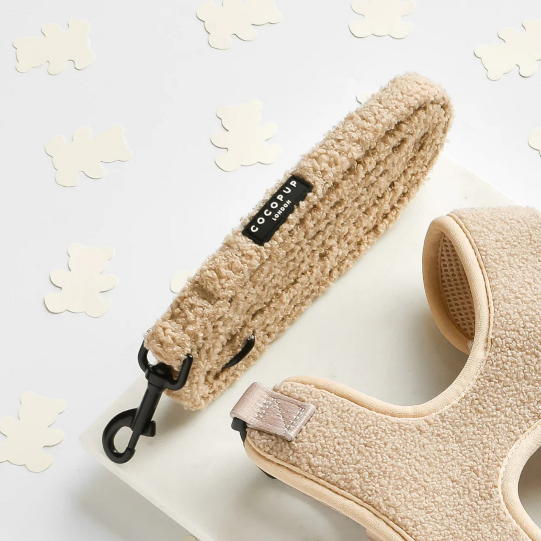 Beige dog lead with a textured strap on a light background