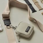 Small beige pouch with a strap and COCOPUP branding on a light background