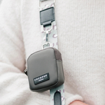 Gray COCOPUP bag with a floral strap on a light background