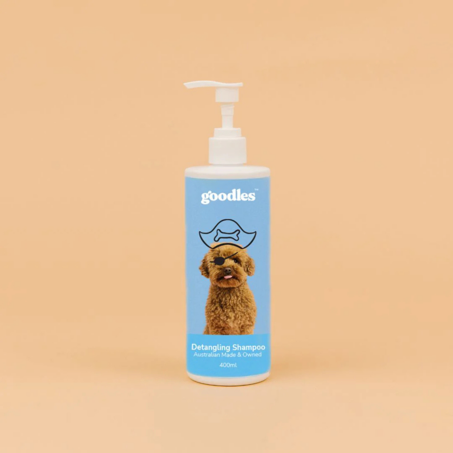 Dog shampoo bottle with blue label featuring a cavoodle dog's face on a beige background