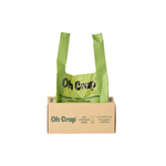 Green compostable dog waste bag with 'Oh Crap' branding on a cardboard box