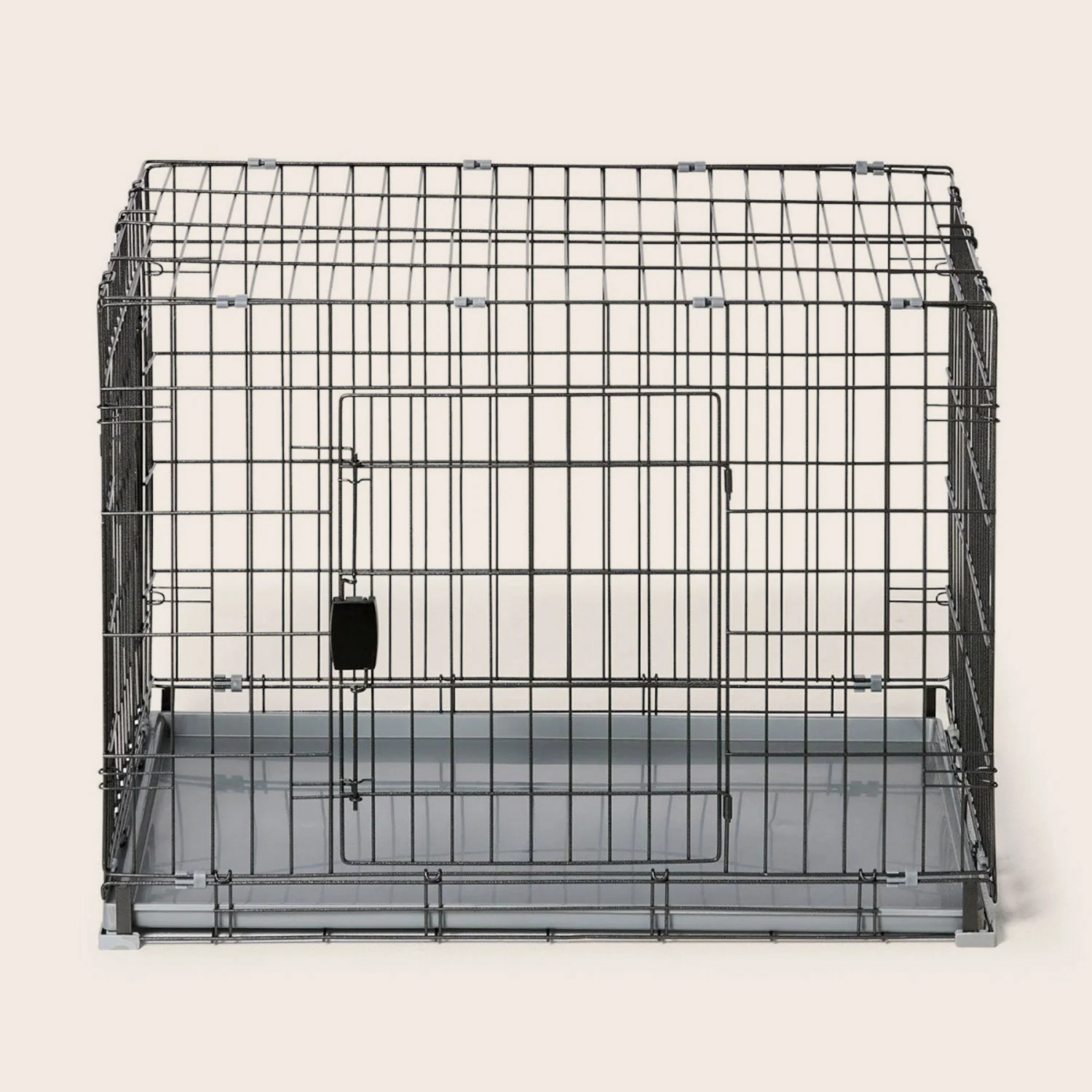 Black metal pet crate on a white background