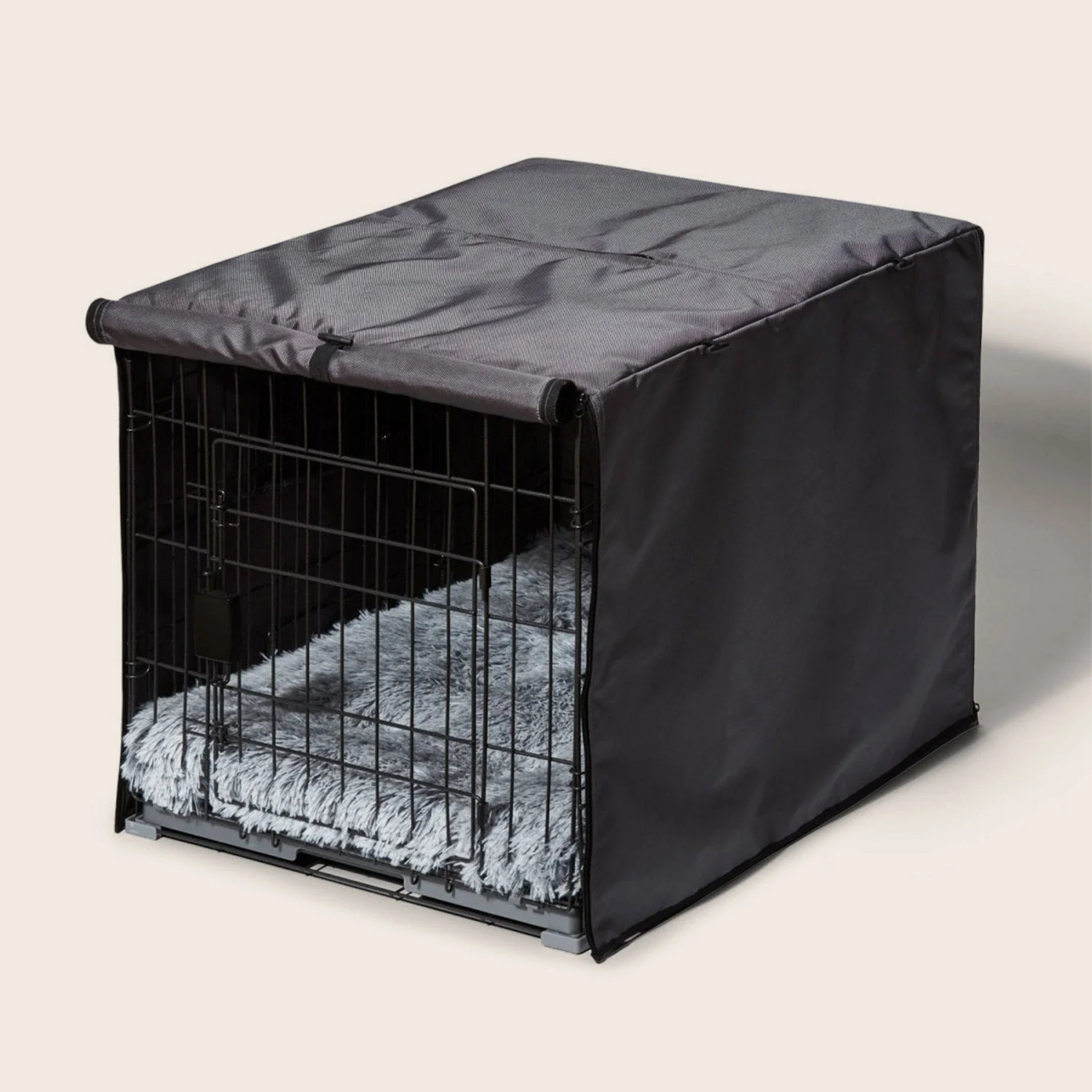 Dog crate with a black cover on a light background