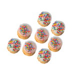 Small cookies with colorful sprinkles on a white background